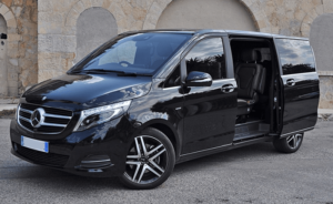 Black Mercedes V-Class minivan with open door, displaying the luxurious interior, ready for upscale small group transport in Paris