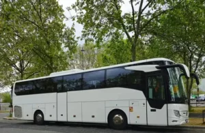 White 53-seater coach parked on a boulevard in Paris