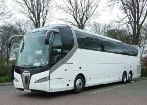 White 55-seater Scania coach with a sleek design parked in Paris